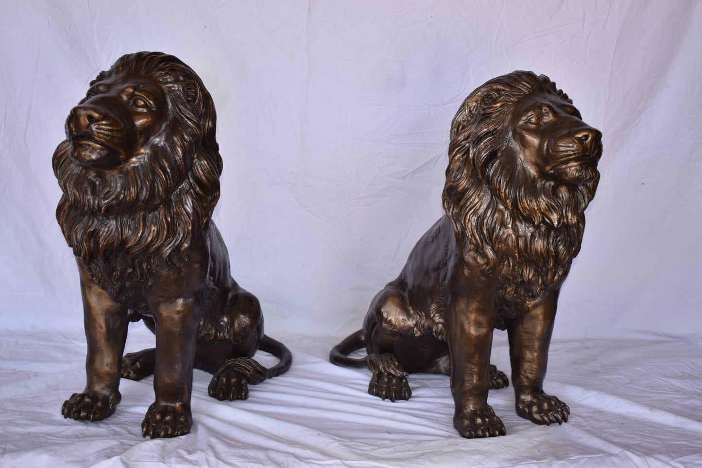 A Pair of Lions Sitting on The Ground Bronze Statues Size: 14" x 27" x 29"H