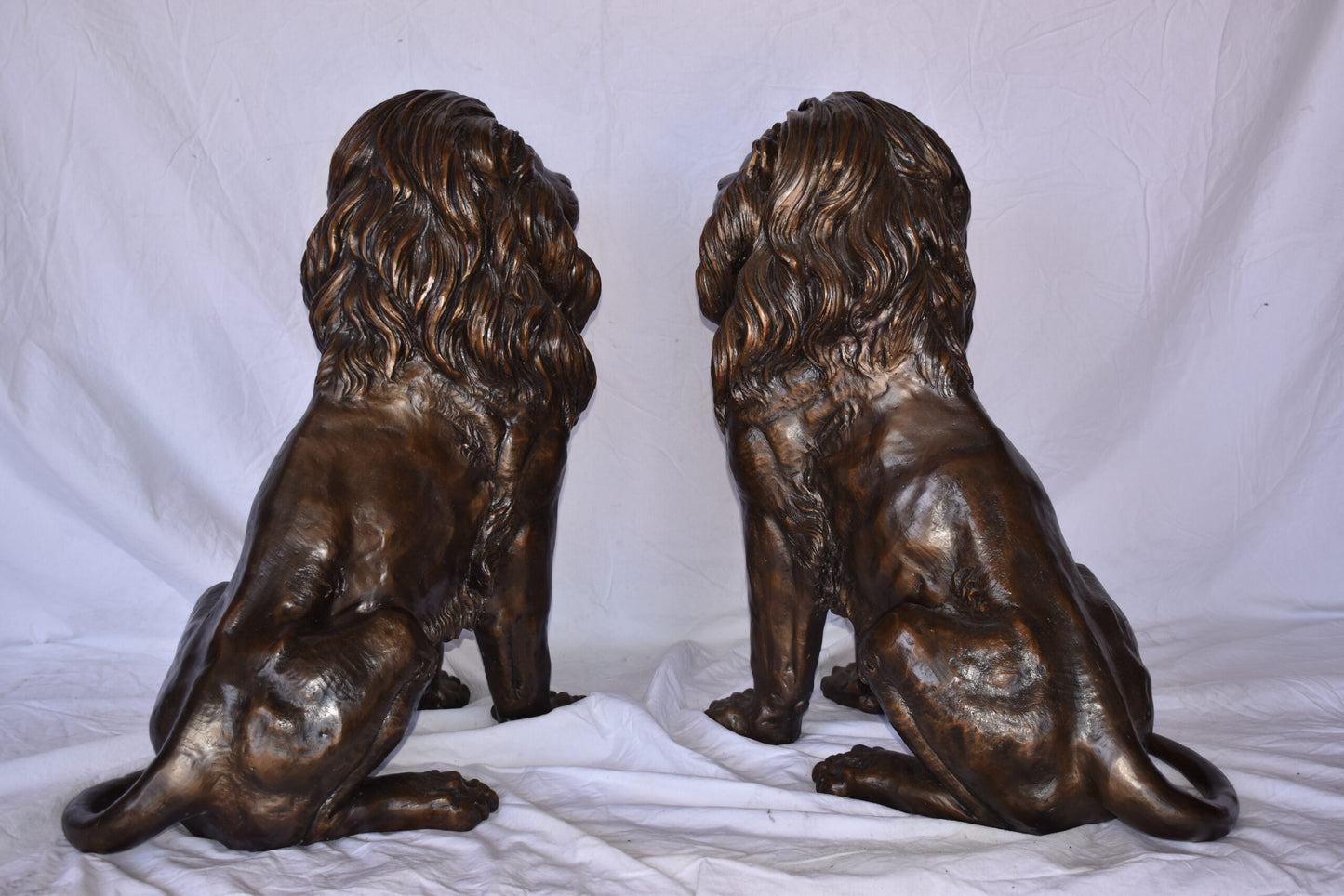 A Pair of Lions Sitting on The Ground Bronze Statues Size: 14" x 27" x 29"H