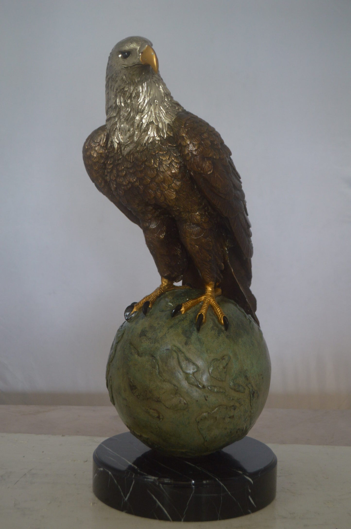 Bald Eagle Standing on a Globe Bronze Statue -  Size: 17"L x 9"W x 23"H.