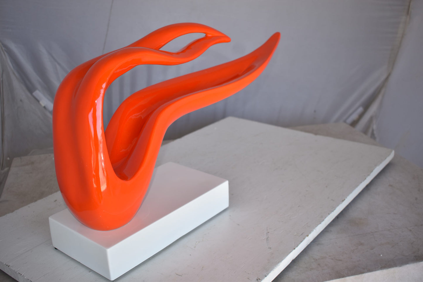 Modern Art Orange Ribbon Resin Statue Mounted on A Base Size: 25" x 6" x 13"H