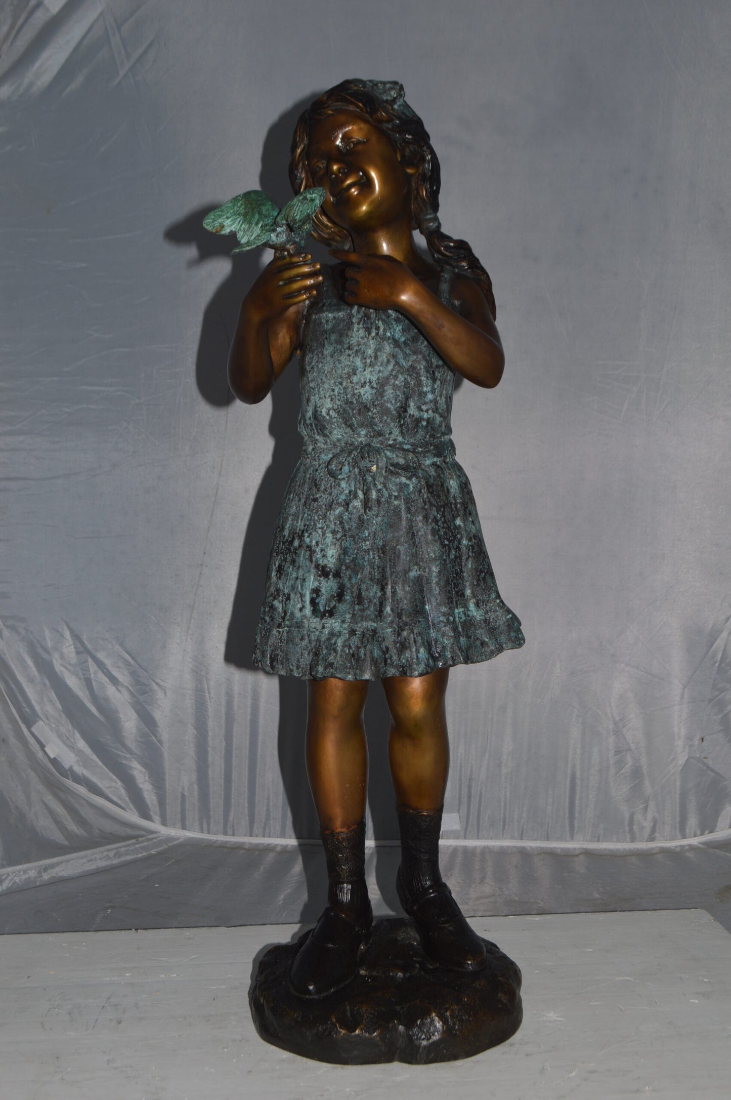 Girl Holding a Bird Bronze Statue -  Size: 12"L x 12"W x 34"H.