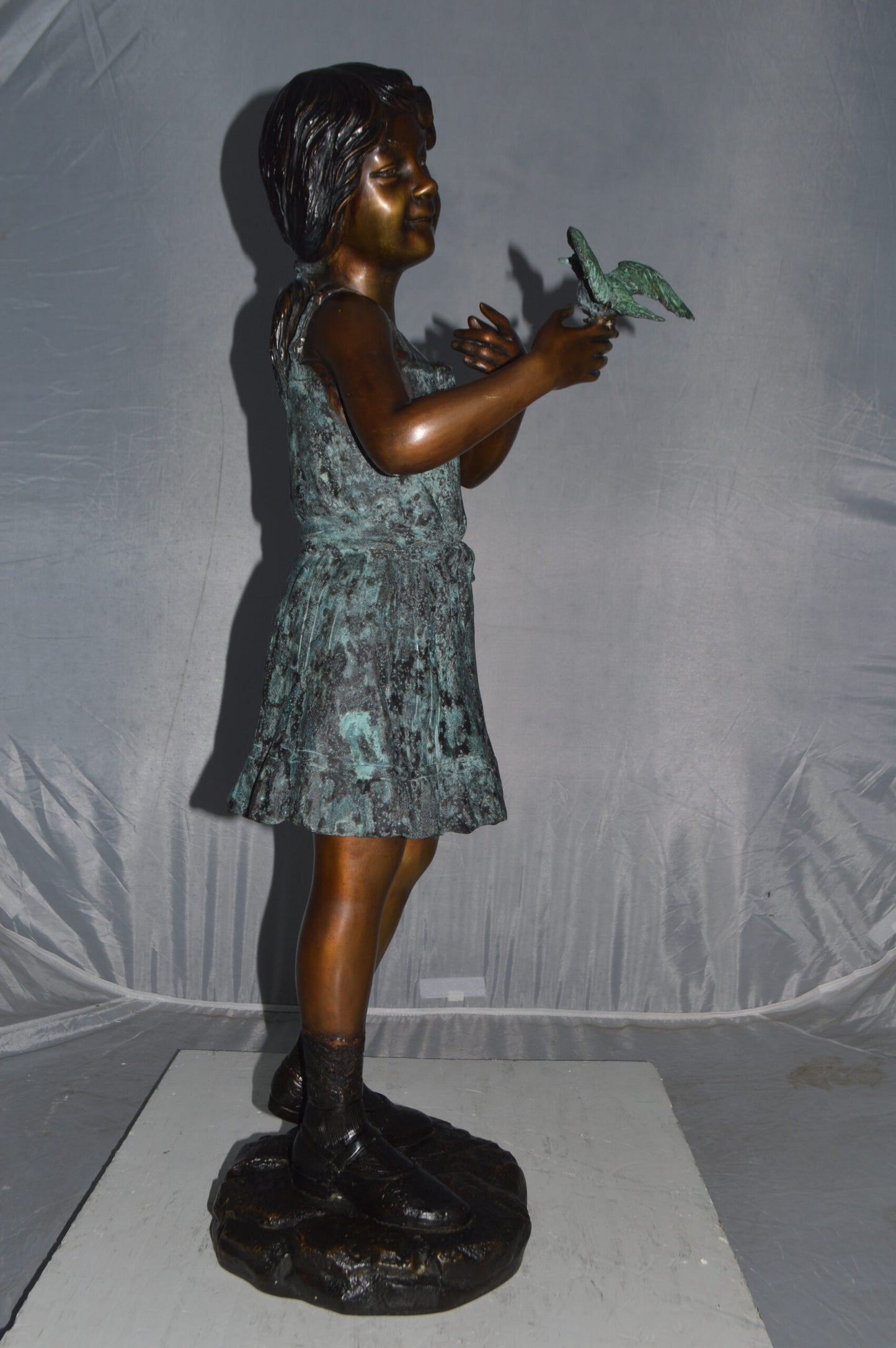 Girl Holding a Bird Bronze Statue -  Size: 12"L x 12"W x 34"H.