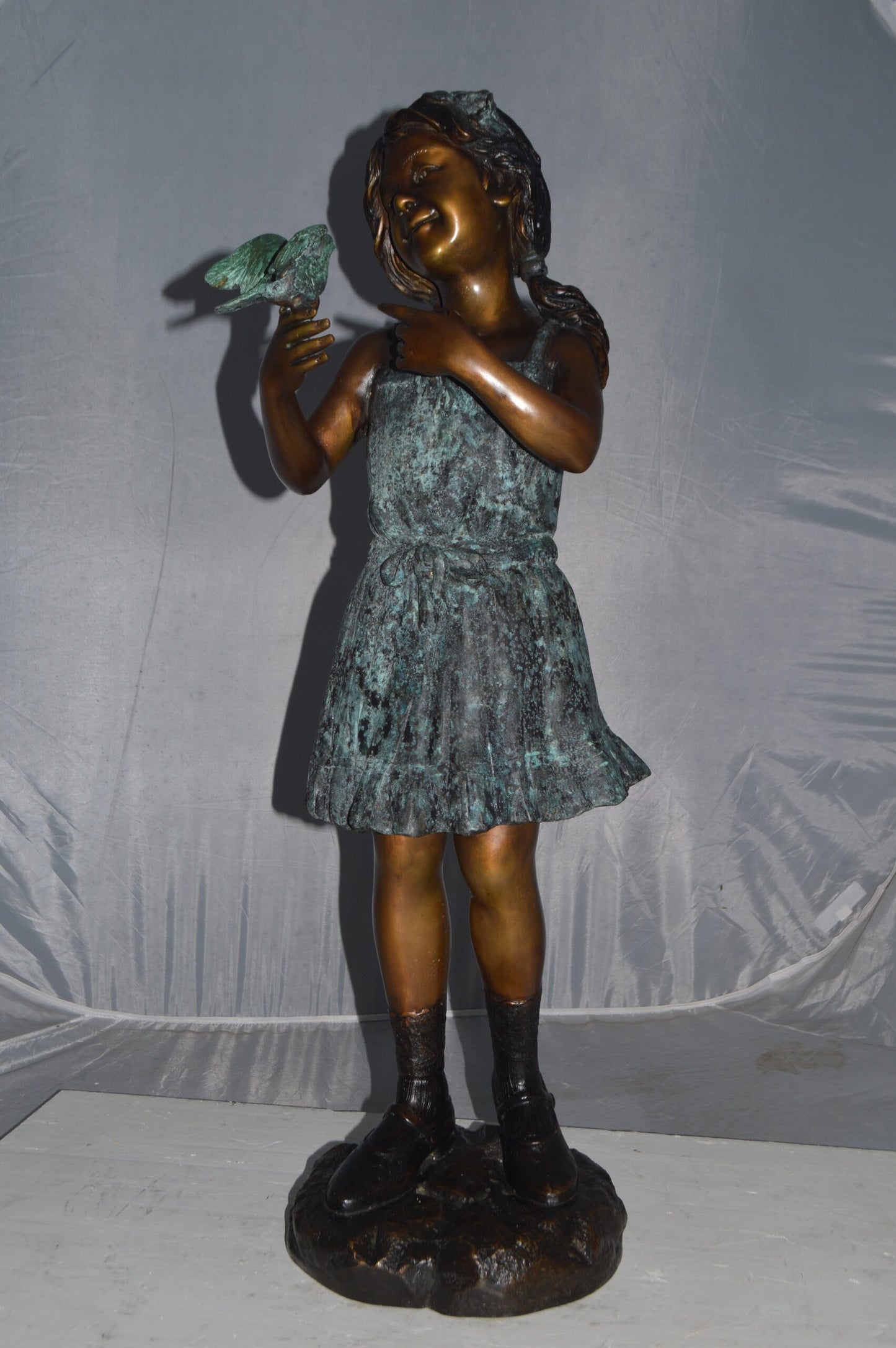 Girl Holding a Bird Bronze Statue -  Size: 12"L x 12"W x 34"H.