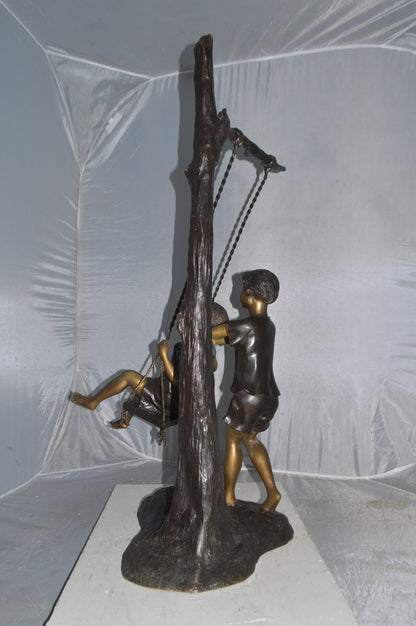 Kids Playing on a Swing bronze Statue -  Size: 22"L x 25"W x 43"H.