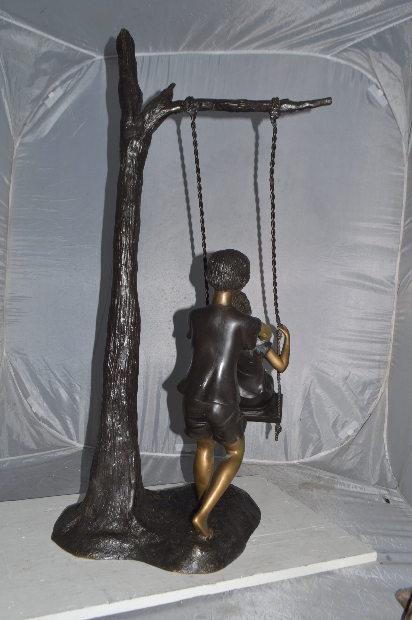 Kids Playing on a Swing bronze Statue -  Size: 22"L x 25"W x 43"H.