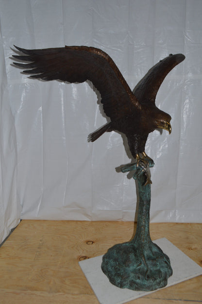 Eagle on a Tree Branch Bronze Statue -  Size: 44"L x 50"W x 65"H.