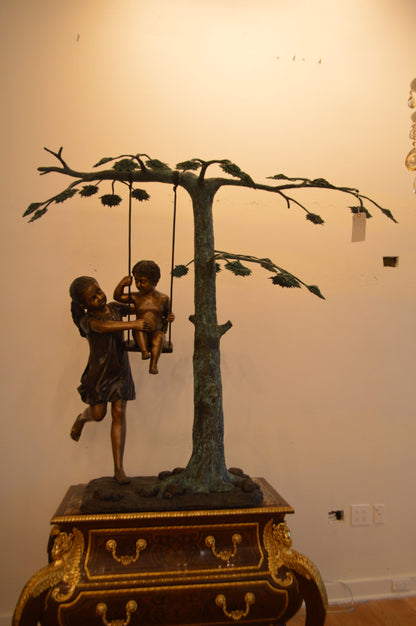 Swing Set Under A Three Bronze Statue -  Size: 60"L x 33"W x 60"H.