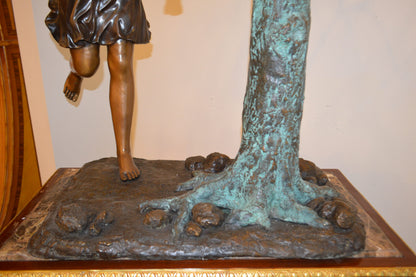 Swing Set Under A Three Bronze Statue -  Size: 60"L x 33"W x 60"H.