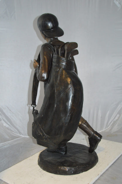 Boy Carrying A Golf Bag Bronze Statue -  Size: 15"L x 15"W x 38"H.