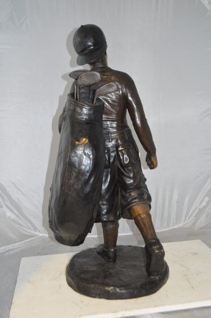 Boy Carrying A Golf Bag Bronze Statue -  Size: 15"L x 15"W x 38"H.