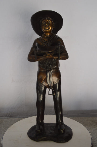 Cowboy Holding a Saddle Bronze Statue  -  Size: 12"L x 11"W x 32"H.