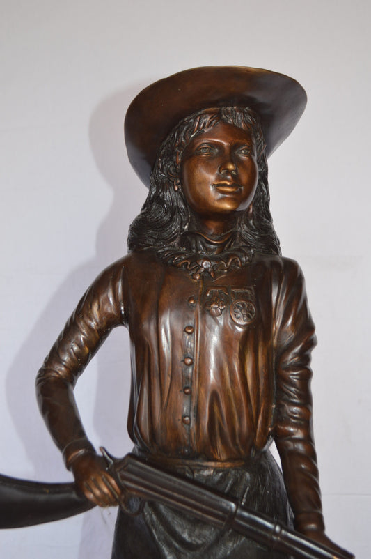 Annie Oakley Bronze Statue Mounted on a Marble Base -  Size: 11"L x 9"W x 33"H.