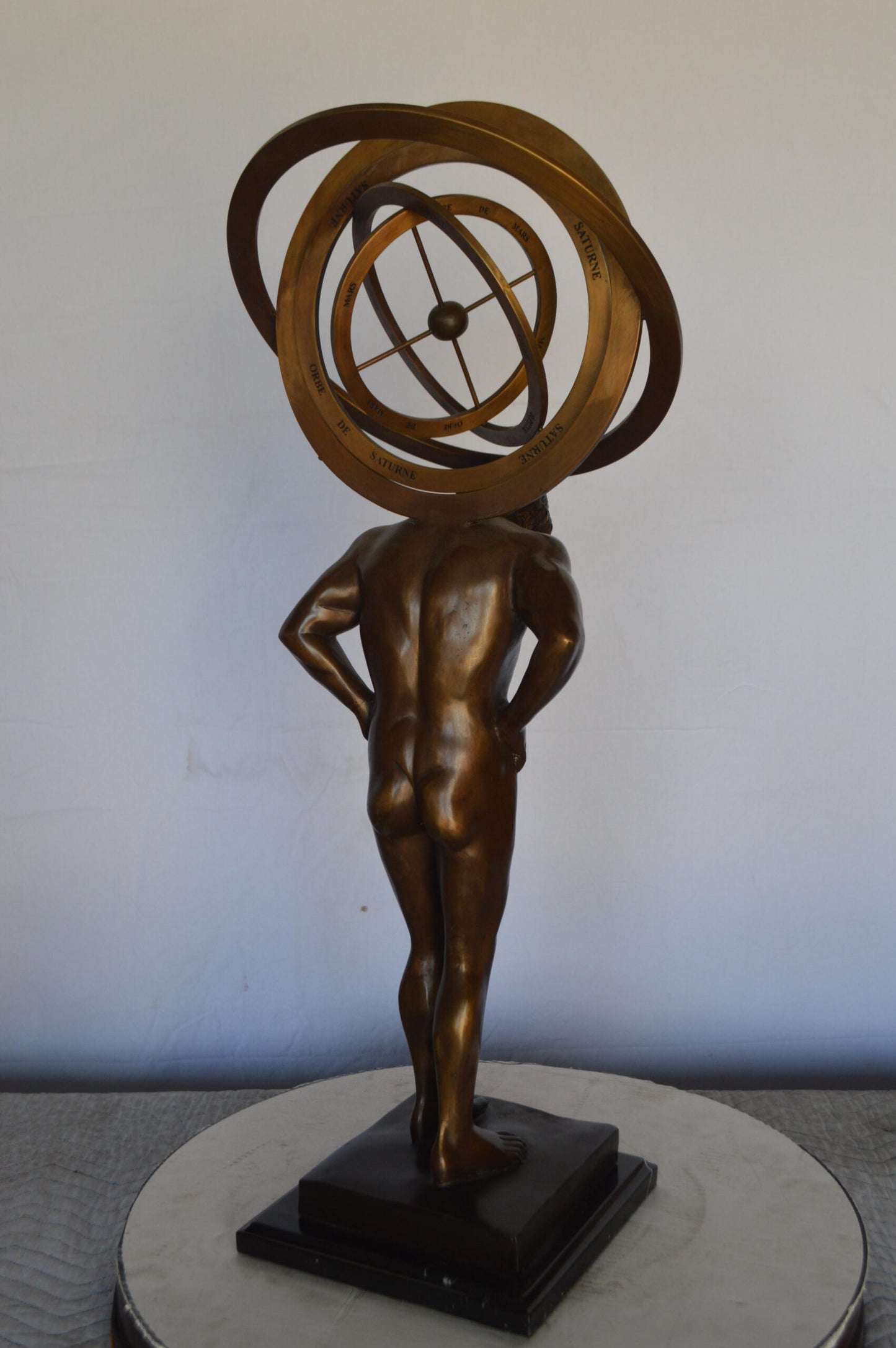 Man with Sundial on his Back Bronze Statue -  Size: 14"L x 12"W x 35"H.