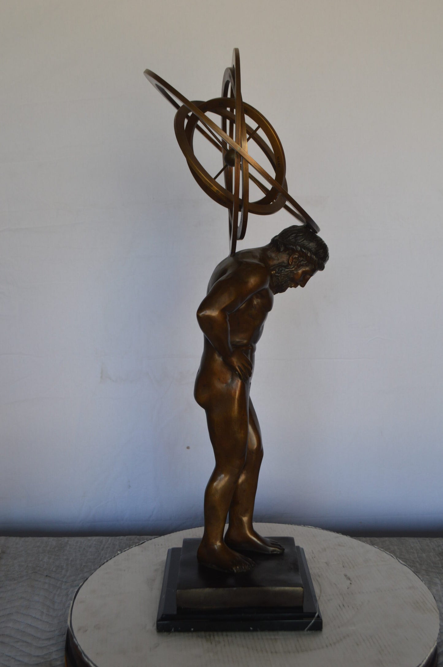 Man with Sundial on his Back Bronze Statue -  Size: 14"L x 12"W x 35"H.