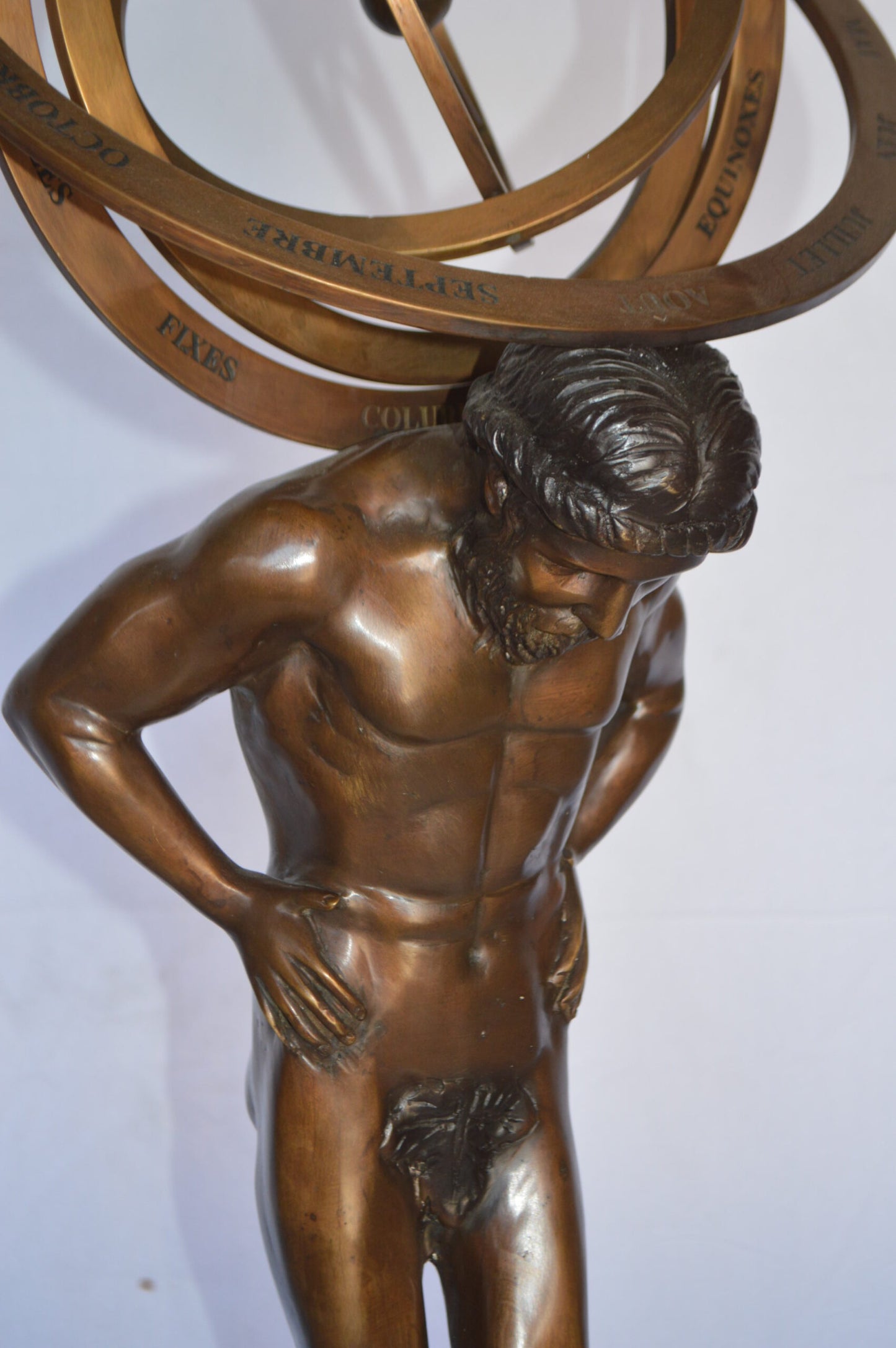 Man with Sundial on his Back Bronze Statue -  Size: 14"L x 12"W x 35"H.