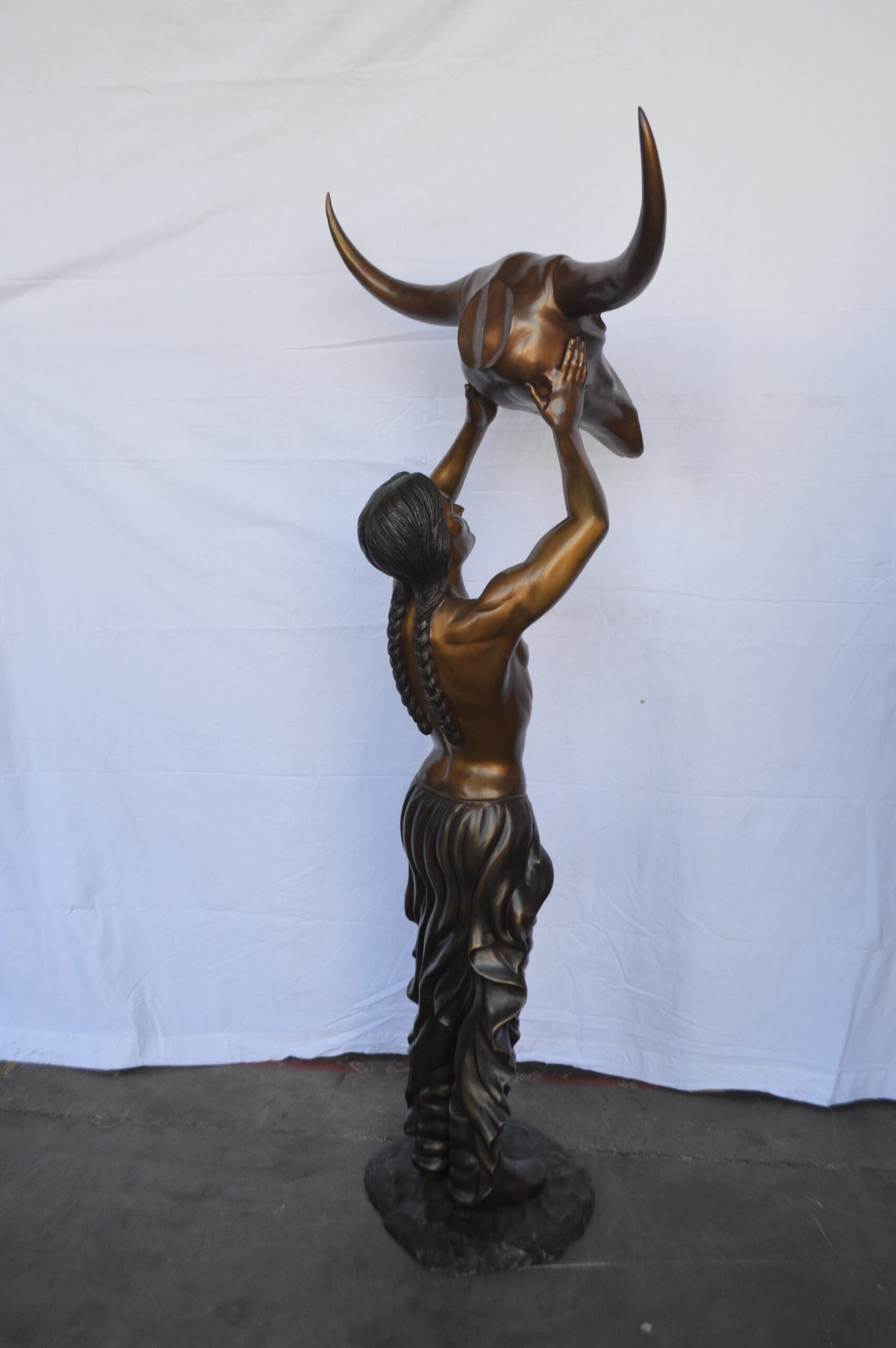 Indian Man Holds a Buffalo Skull Bronze Statue -  Size: 29"L x 23"W x 72"H.