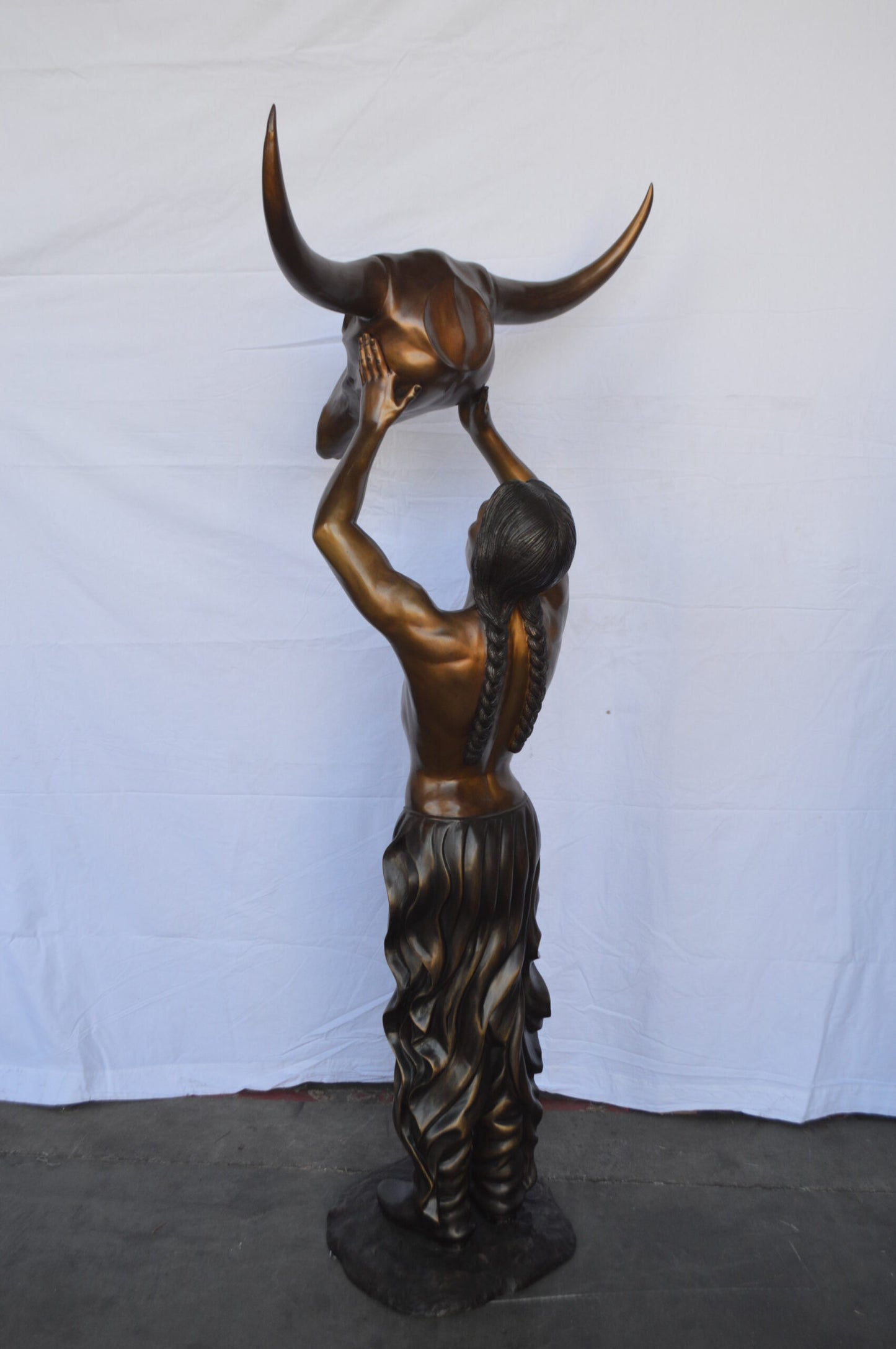 Indian Man Holds a Buffalo Skull Bronze Statue -  Size: 29"L x 23"W x 72"H.