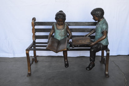 Boy And Girl Reading Books on Bench Bronze Statue -  Size: 48"L x 29"W x 39"H.