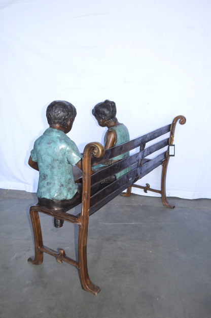 Boy And Girl Reading Books on Bench Bronze Statue -  Size: 48"L x 29"W x 39"H.