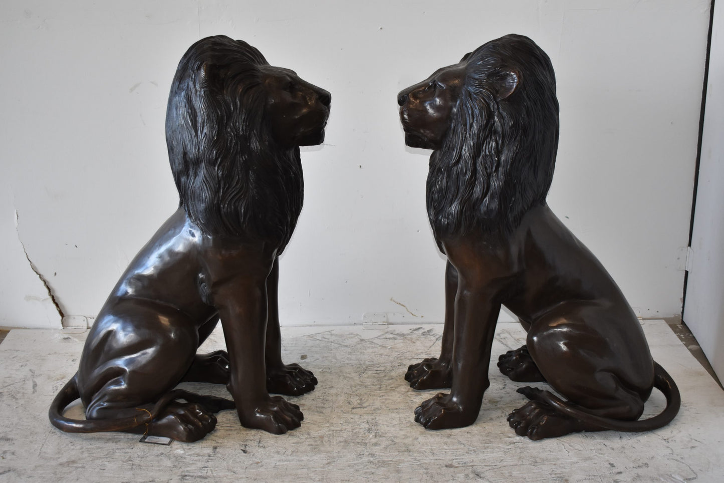 A Pair of Large Lions Sitting Side by Side Bronze Statues Size: 23" x 33" x 46"H