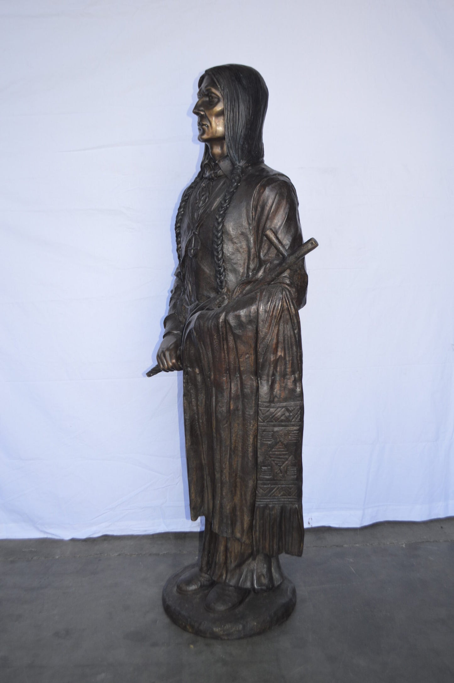 Indian Holding a Pipe Bronze Statue Life Size -  Size: 26"L x 14"W x 68"H.