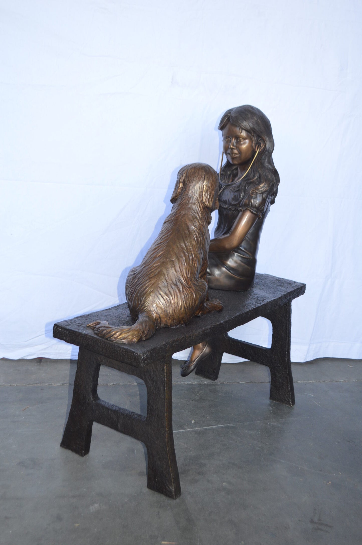 Girl plays Doctor on a Bench W Dog Bronze Statue -  Size: 38"L x 18"W x 39"H.