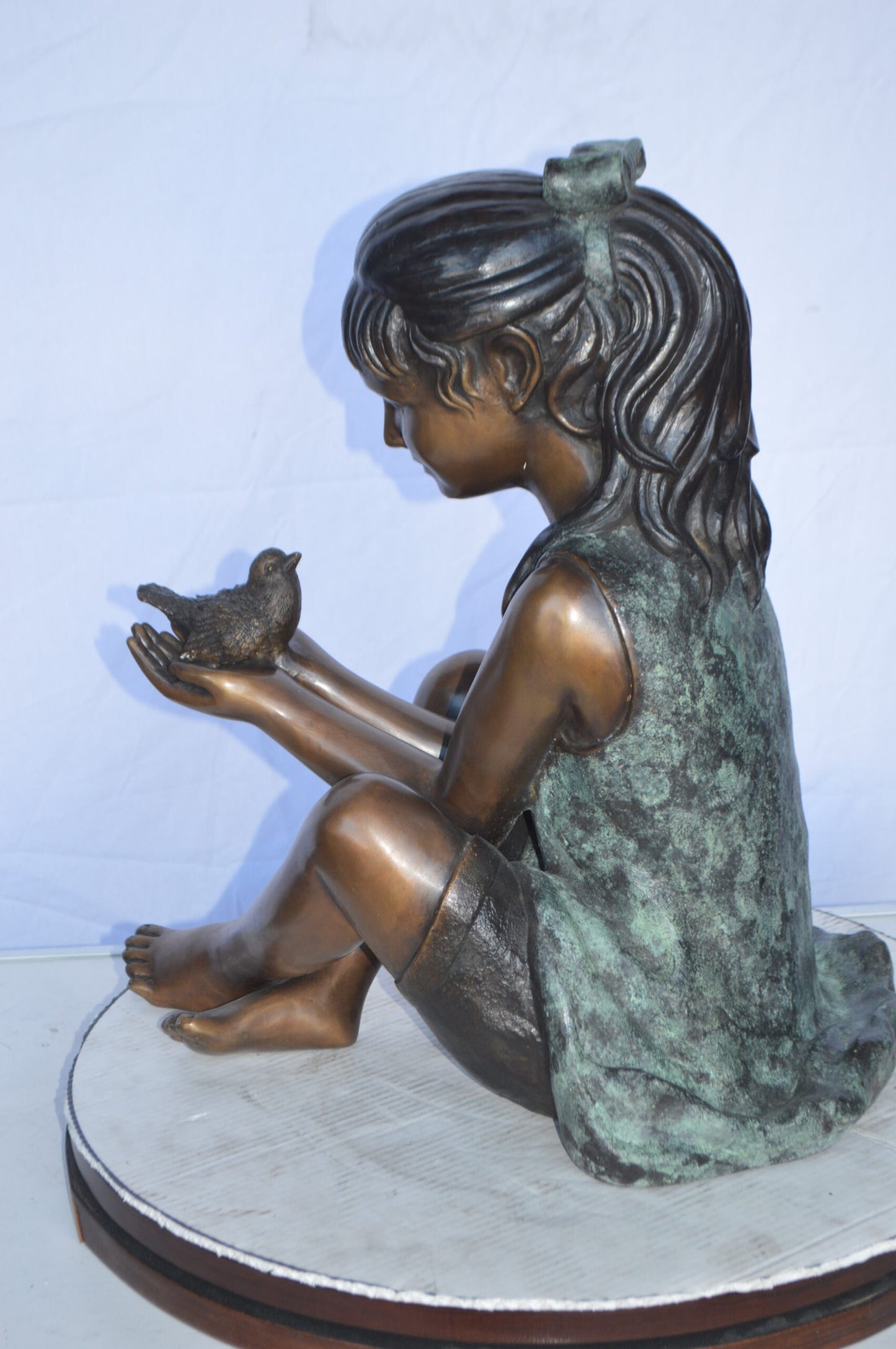 Girl Knees Up Holding a Bird Bronze Statue -  Size: 22"L x 14"W x 24"H.