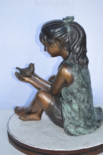 Girl Knees Up Holding a Bird Bronze Statue -  Size: 22"L x 14"W x 24"H.