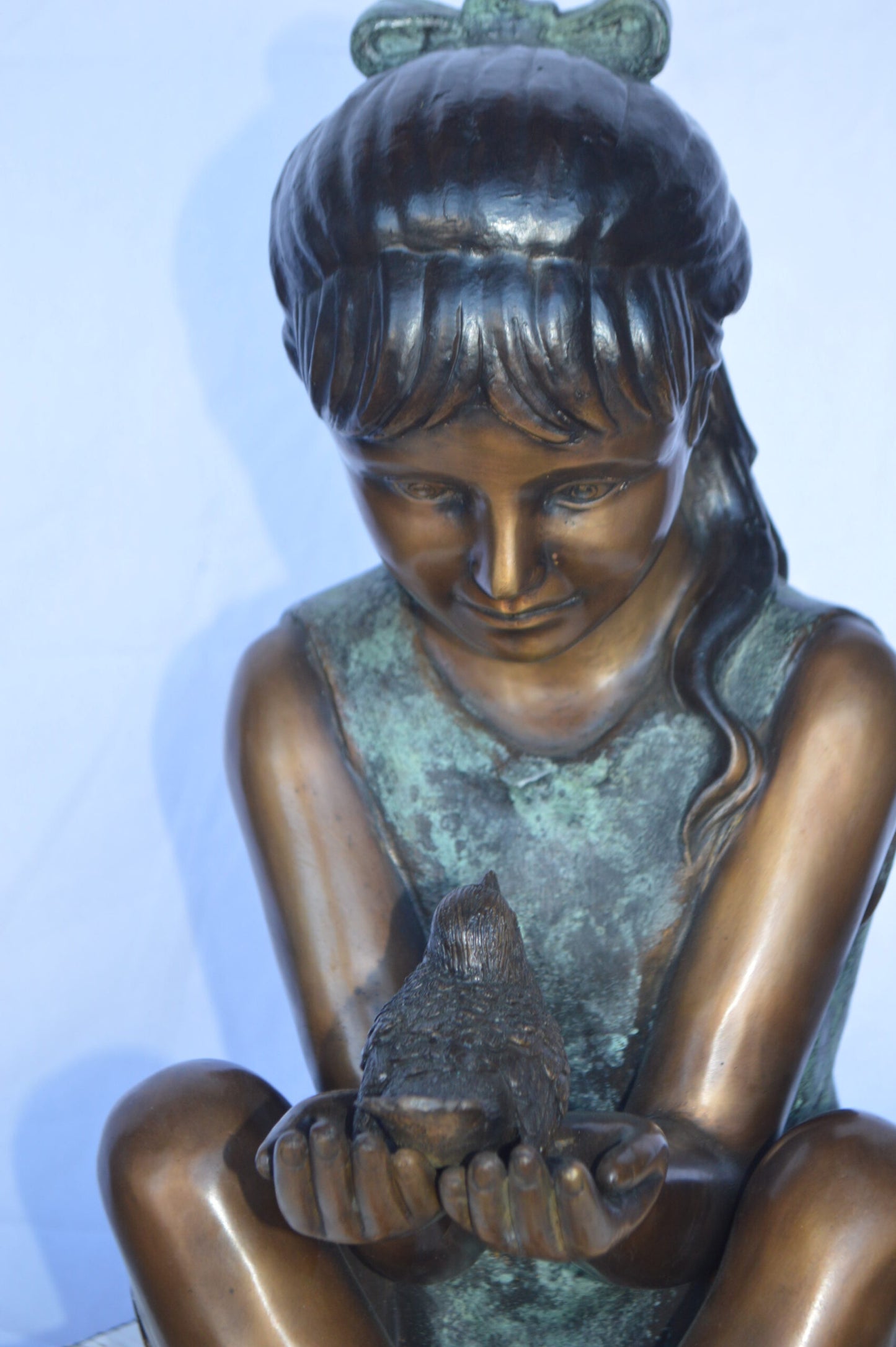 Girl Knees Up Holding a Bird Bronze Statue -  Size: 22"L x 14"W x 24"H.