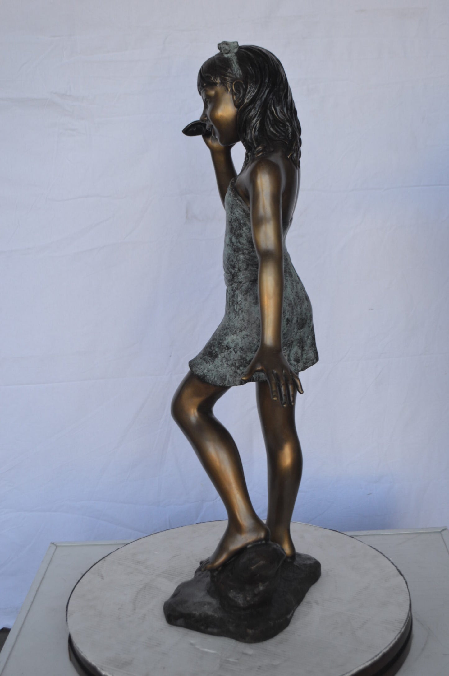 Standing Girl Listening to a Shell Bronze Statue -  Size: 16"L x 12"W x 37"H.