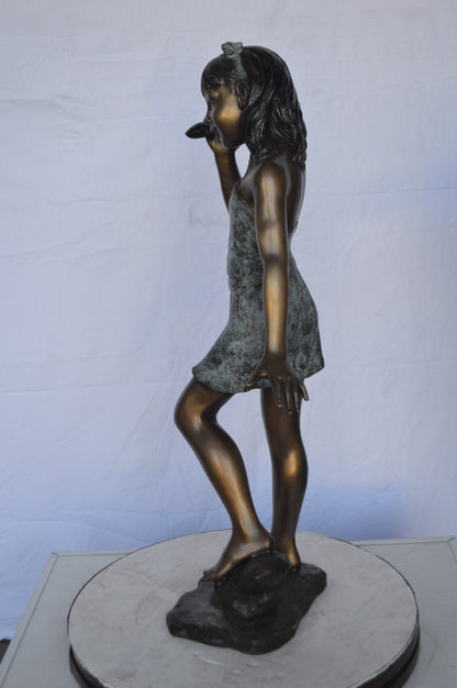 Standing Girl Listening to a Shell Bronze Statue -  Size: 16"L x 12"W x 37"H.