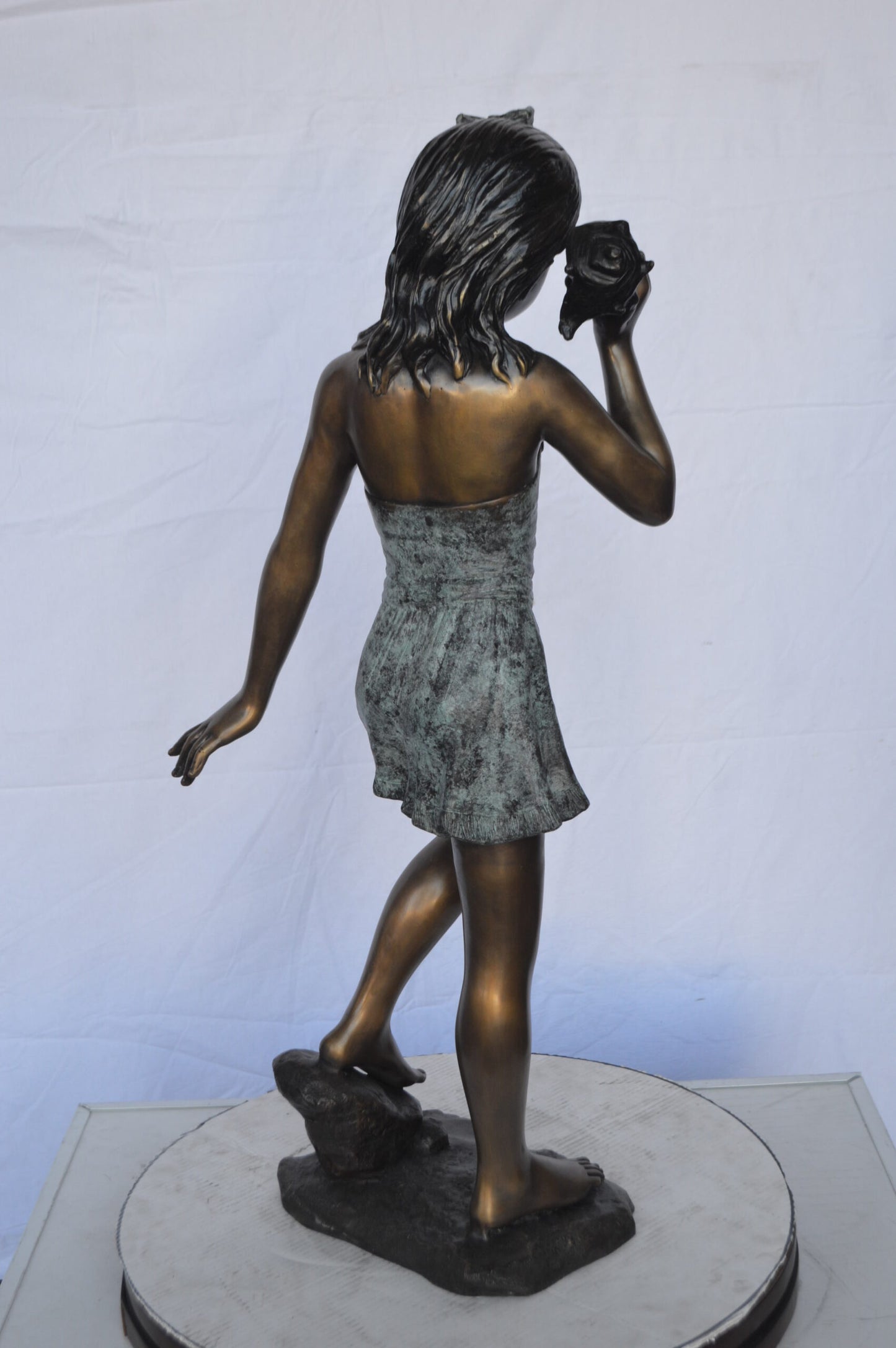 Standing Girl Listening to a Shell Bronze Statue -  Size: 16"L x 12"W x 37"H.