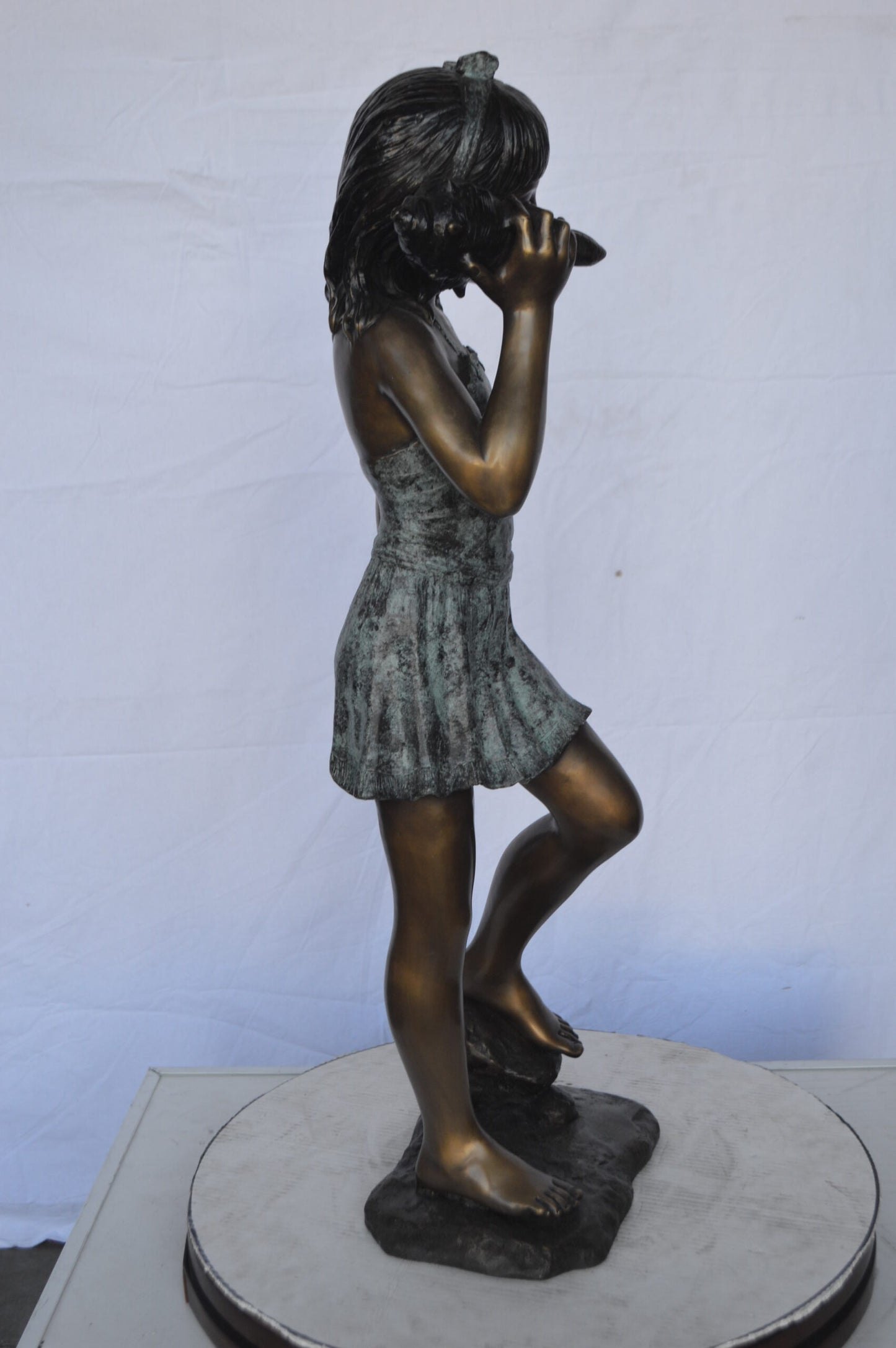 Standing Girl Listening to a Shell Bronze Statue -  Size: 16"L x 12"W x 37"H.