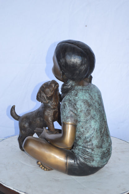 Girl Petting her Dog While Reading Bronze Statue -  Size: 13"L x 18"W x 18"H.
