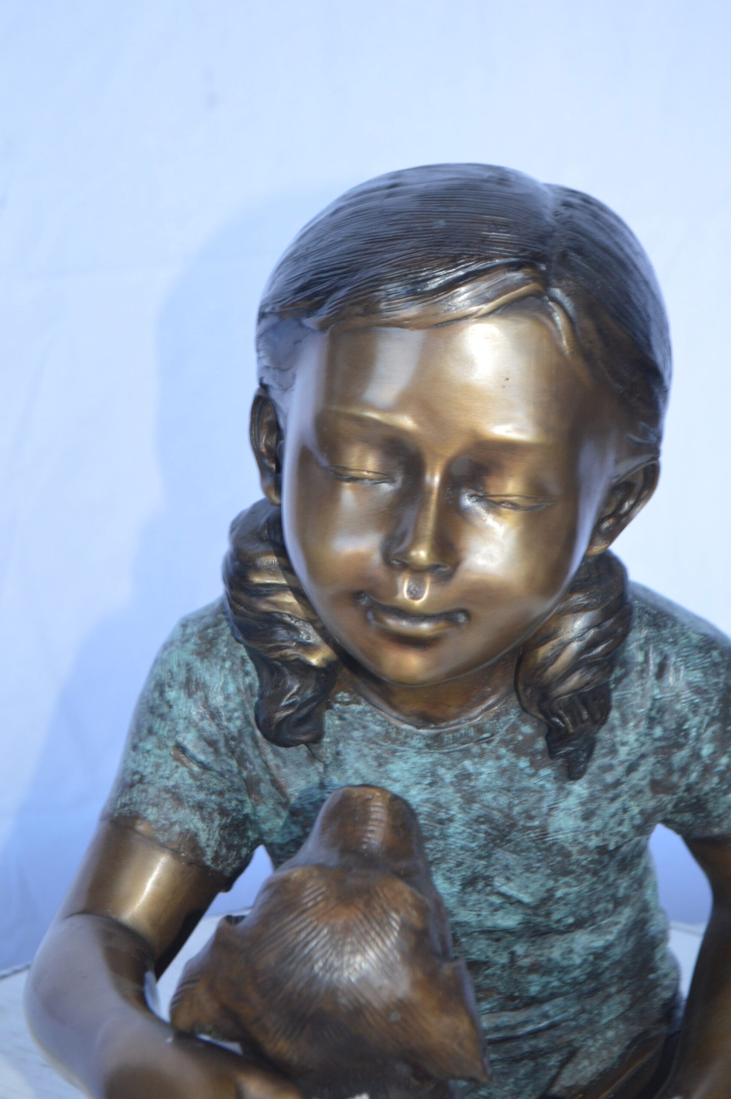 Girl Petting her Dog While Reading Bronze Statue -  Size: 13"L x 18"W x 18"H.
