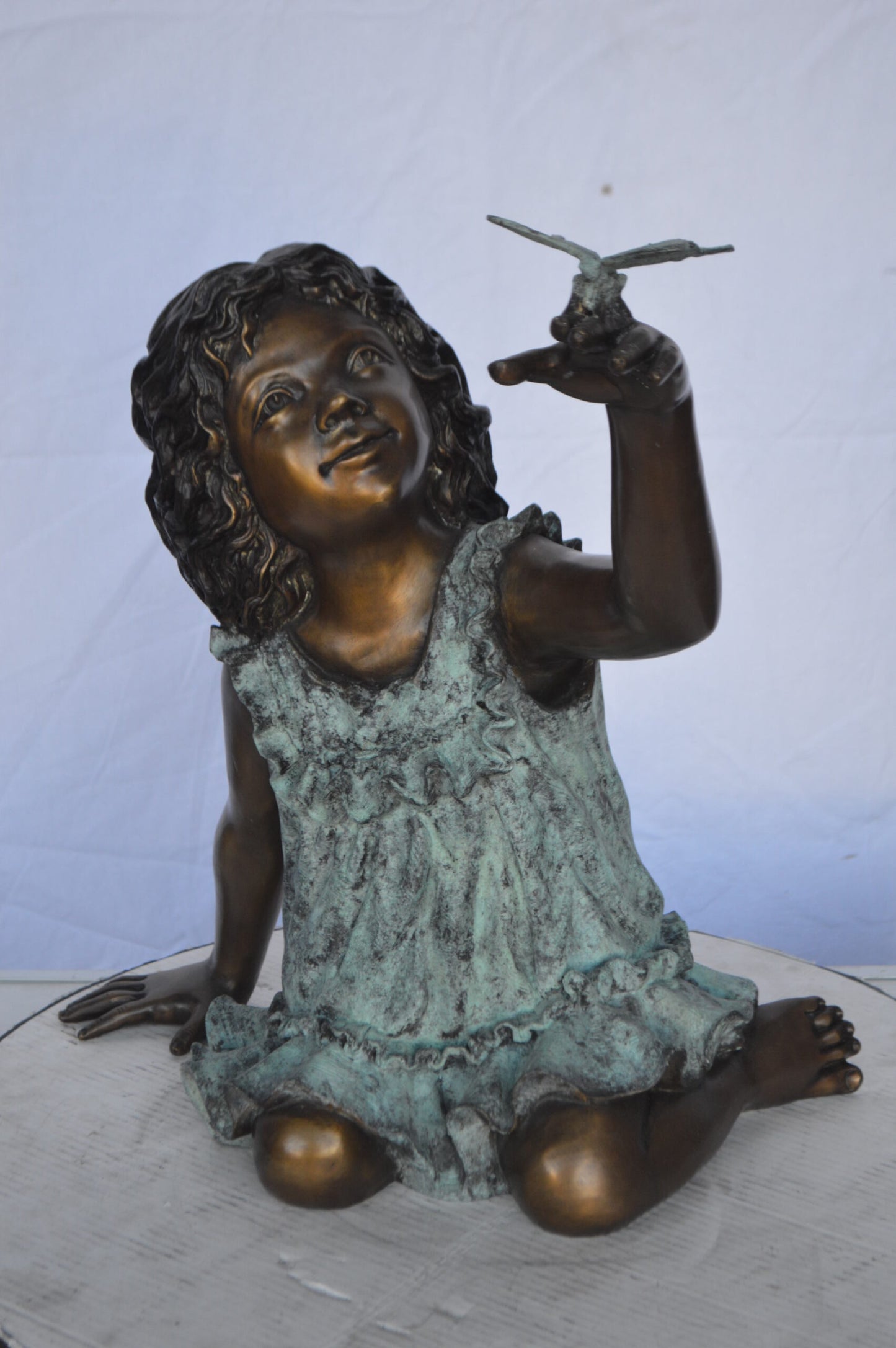 Girl Playing With Butterfly Bronze Statue -  Size: 21"L x 15"W x 19"H.