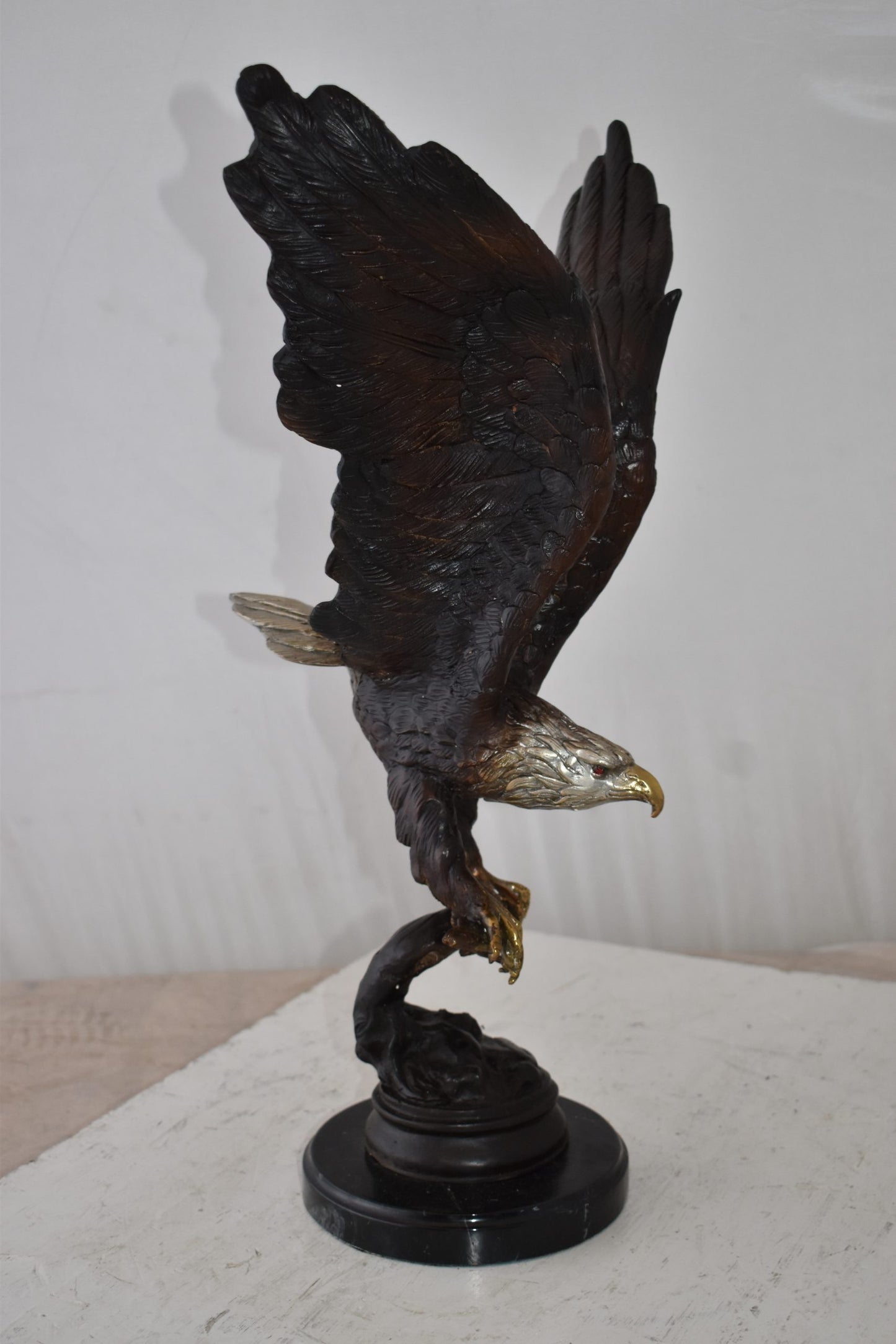 Eagle Holding His Fish Prey Flying Away Bronze Statue Size: 14" x 11" x 23"H