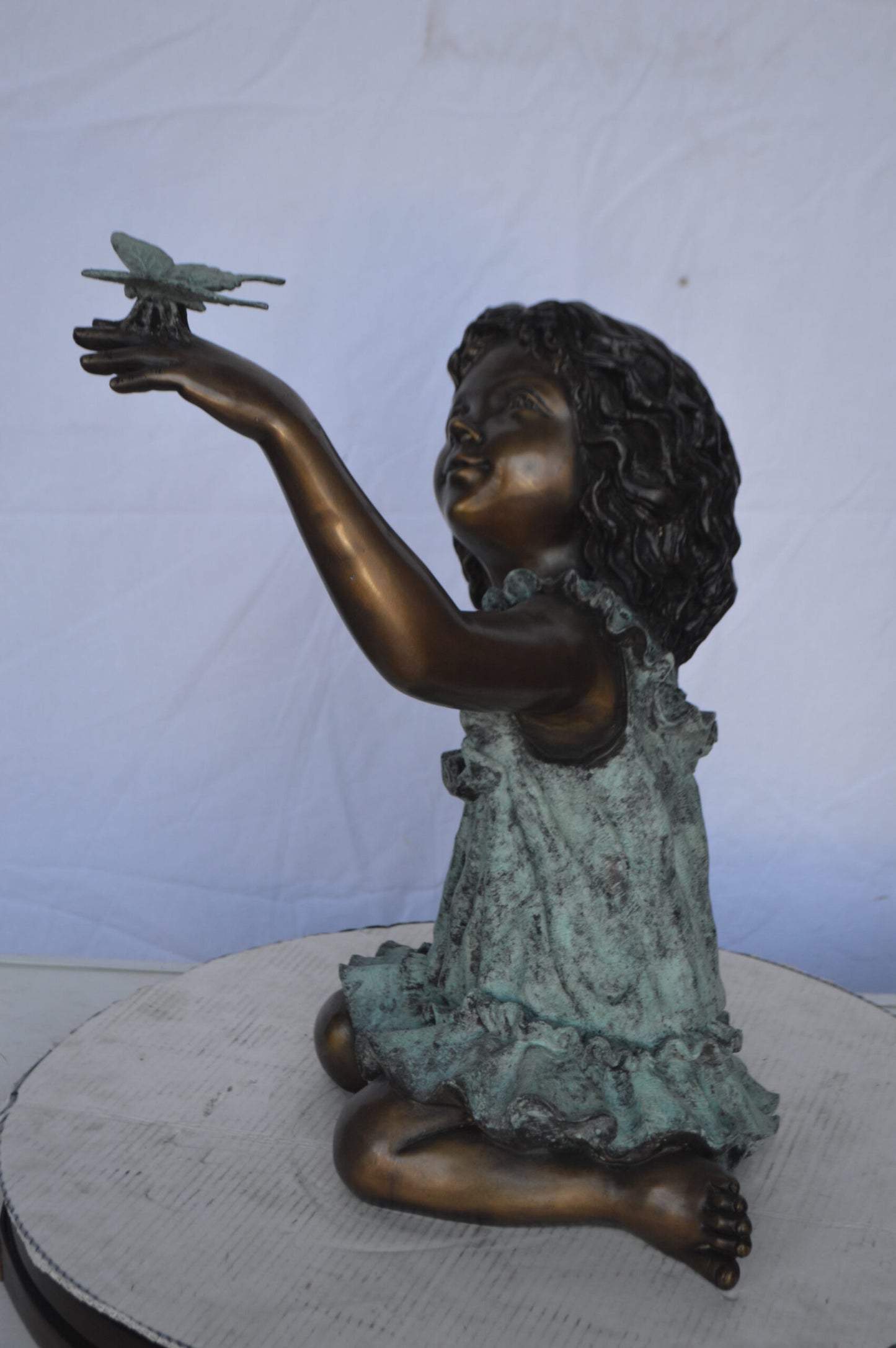 Girl Playing With Butterfly Bronze Statue -  Size: 21"L x 15"W x 19"H.