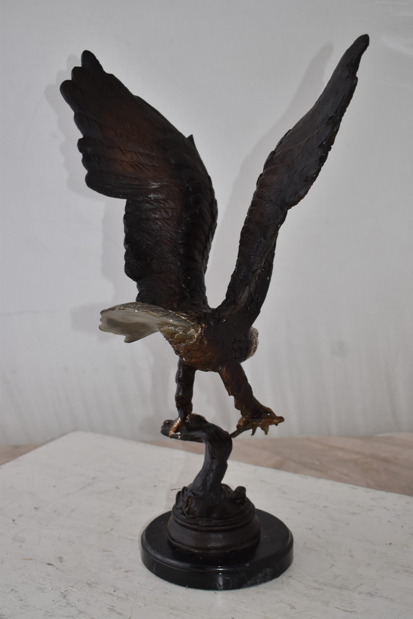 Eagle Holding His Fish Prey Flying Away Bronze Statue Size: 14" x 11" x 23"H