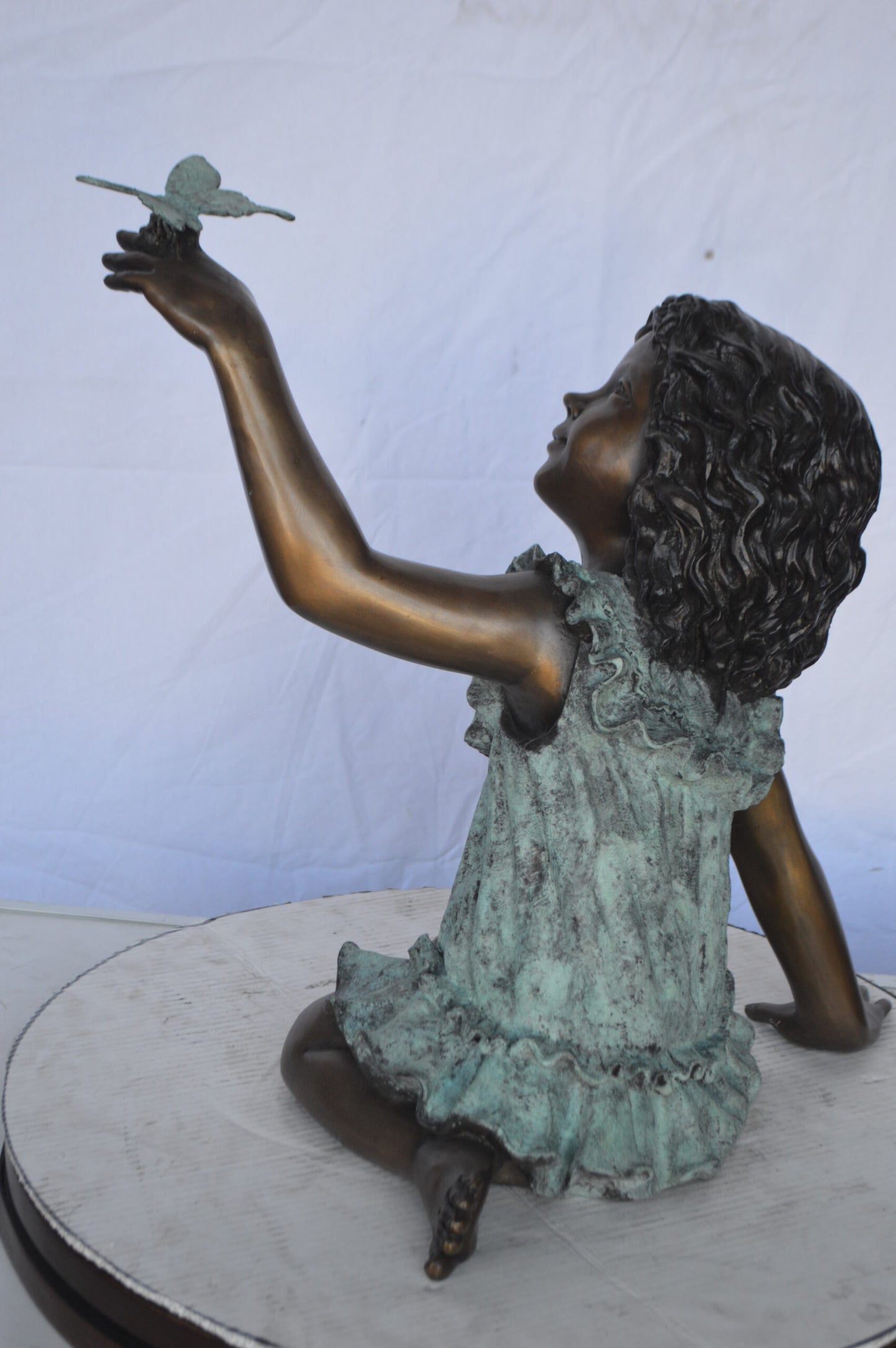 Girl Playing With Butterfly Bronze Statue -  Size: 21"L x 15"W x 19"H.