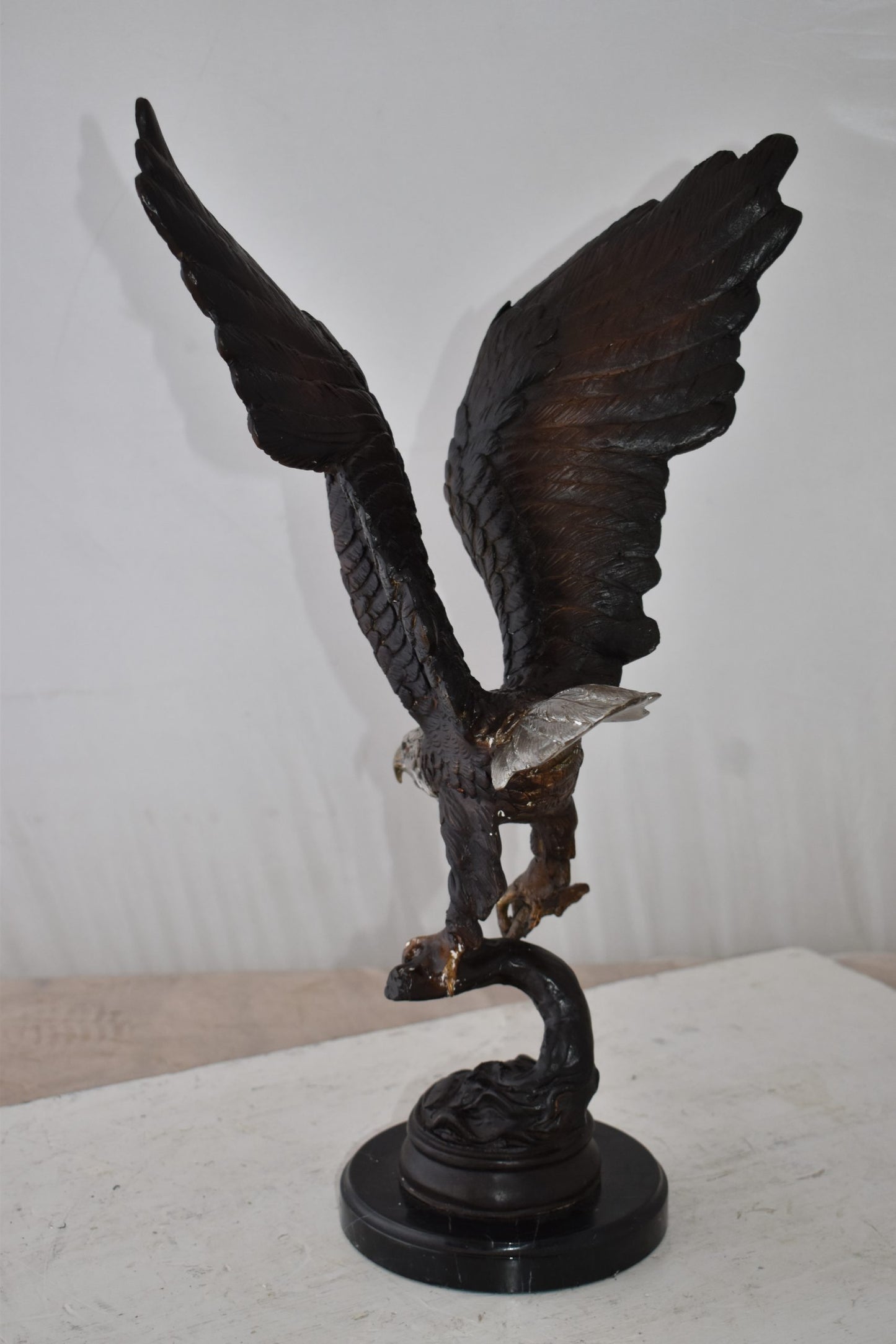 Eagle Holding His Fish Prey Flying Away Bronze Statue Size: 14" x 11" x 23"H