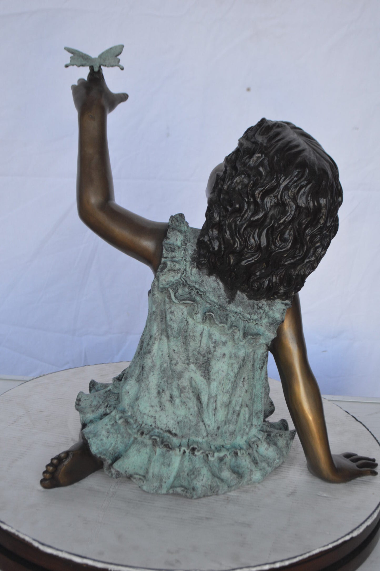 Girl Playing With Butterfly Bronze Statue -  Size: 21"L x 15"W x 19"H.