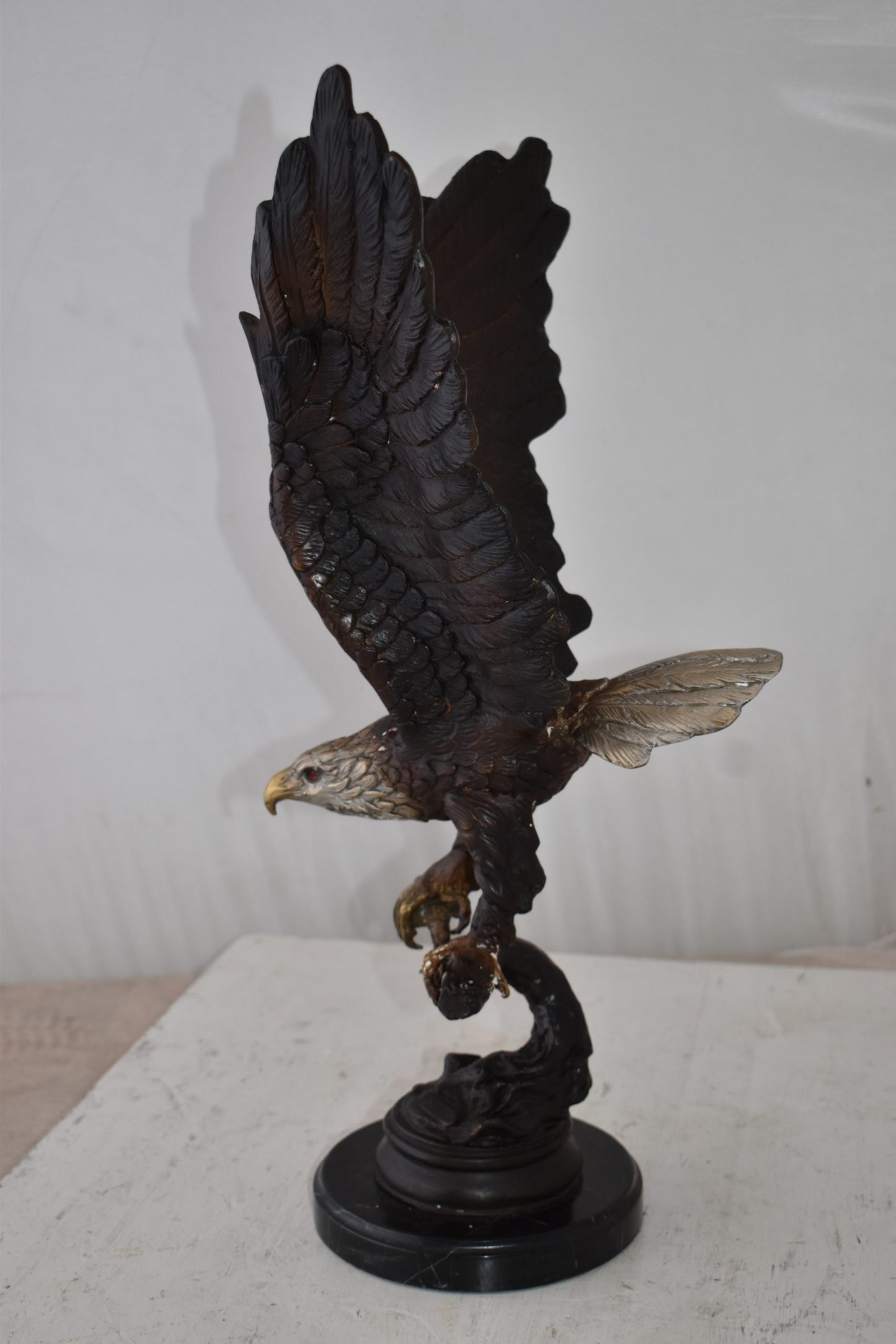 Eagle Holding His Fish Prey Flying Away Bronze Statue Size: 14" x 11" x 23"H