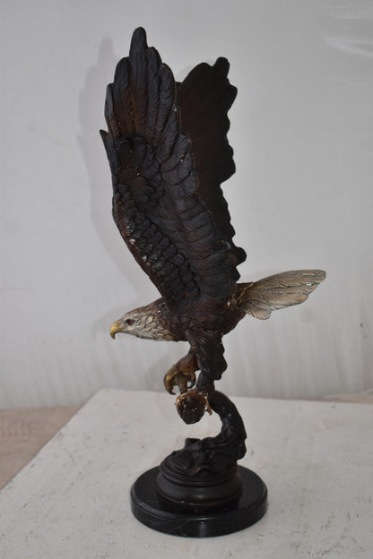 Eagle Holding His Fish Prey Flying Away Bronze Statue Size: 14" x 11" x 23"H
