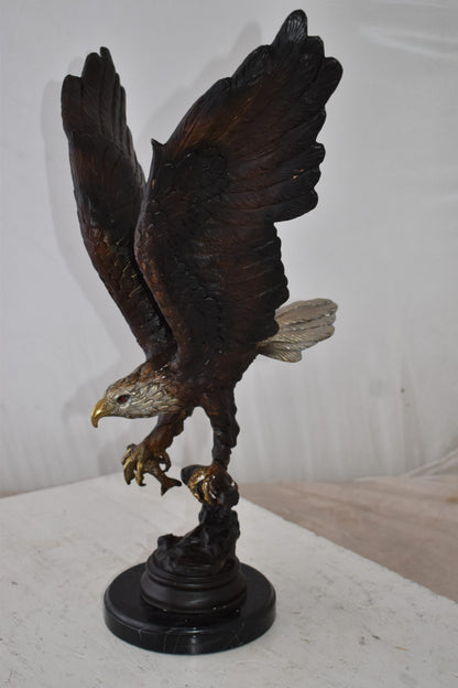 Eagle Holding His Fish Prey Flying Away Bronze Statue Size: 14" x 11" x 23"H