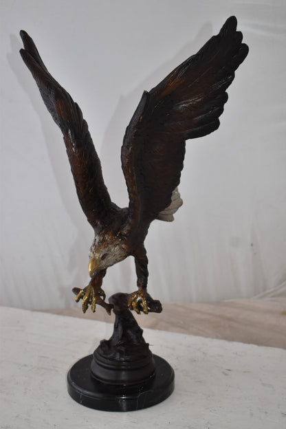 Eagle Holding His Fish Prey Flying Away Bronze Statue Size: 14" x 11" x 23"H