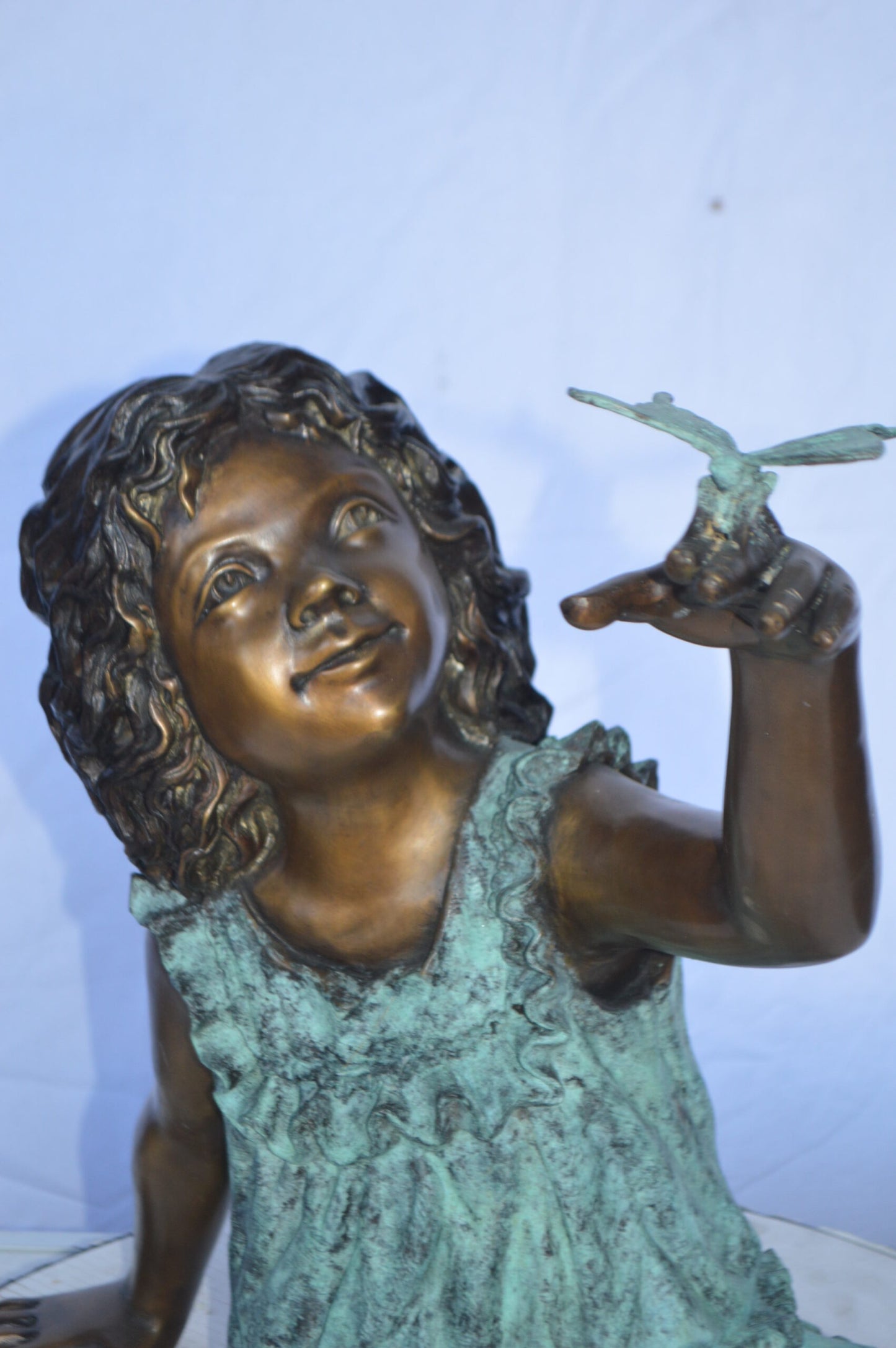 Girl Playing With Butterfly Bronze Statue -  Size: 21"L x 15"W x 19"H.