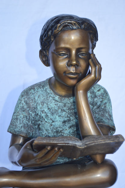 Boy Sitting on a Stump Reading a Book -  Size: 18"L x 20"W x 35"H.