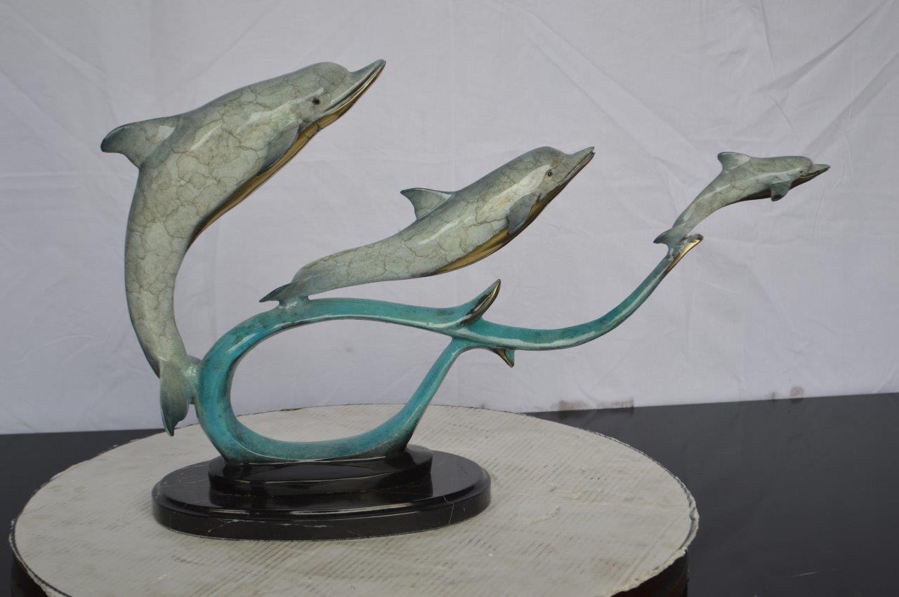 Three dolphins swimming bronze state -  Size: 26"L x 7"W x 16"H.