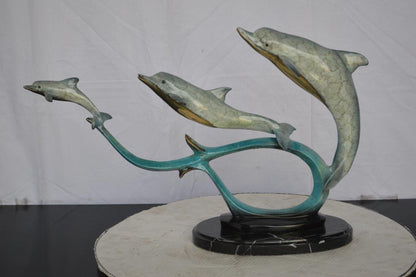 Three dolphins swimming bronze state -  Size: 26"L x 7"W x 16"H.